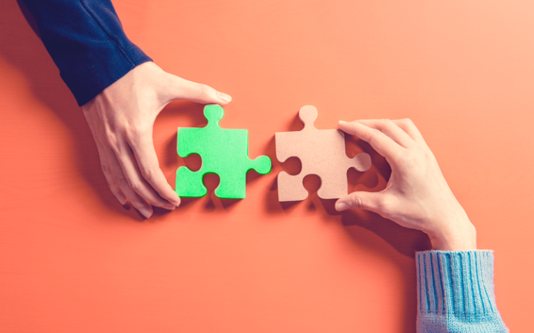 Montagem de duas peças de quebra-cabeça, fazendo alusão à combinação de perfil comportamental para o encaixe perfeito de pessoas em uma equipe de trabalho.